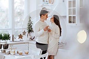 Affectionate couple hugging in kitchen