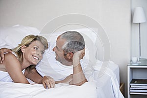 Affectionate Couple Relaxing On Bed photo