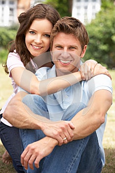 Affectionate Couple Relaxing At Home In Garden Tog photo