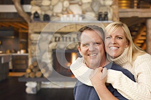 Affectionate Couple at Rustic Fireplace in Log Cabin