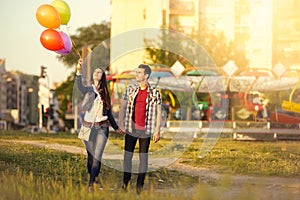 Affectionate couple walking in the amusement park