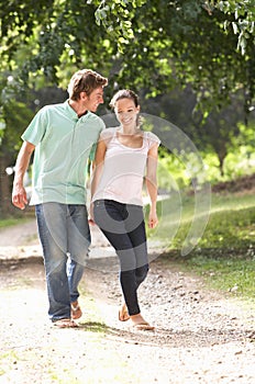 Affectionate Couple Walking In Countryside Togethe photo