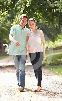 Affectionate Couple Walking In Countryside Togethe