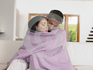 Affectionate Couple Wrapped In Blanket