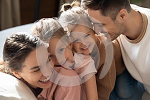 Affectionate family of four enjoying sweet tender weekend moment.