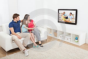Affectionate family watching tv photo