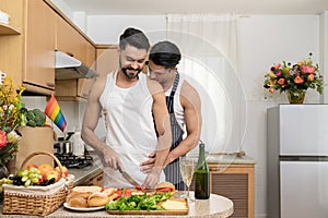 Affectionate gay couple enjoy cooking at kitchen together