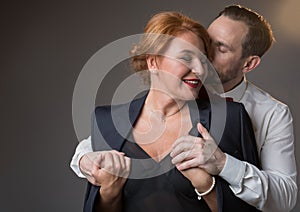Affectionate gentleman kissing lady with fondness