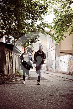 Happy couple running outdoor.