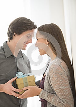 Affectionate Man Giving Birthday Gift To Woman