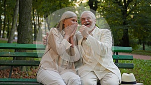 Affectionate mature family Caucasian senior elderly couple woman man smiling talking discuss laughing enjoying pleasant