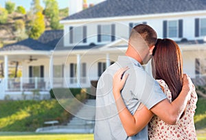 Affectionate Military Couple Looking at Beautiful New House photo