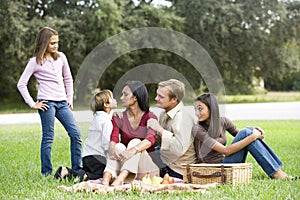 Affectionate modern multicultural family on picnic