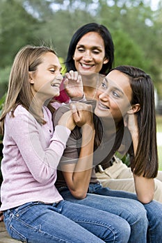 Affectionate mother and two daughters laughing photo