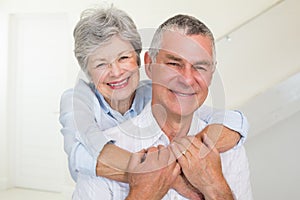 Affectionate retired couple smiling at camera