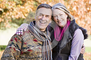 Affectionate senior couple on autumn walk photo