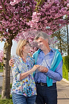 Affectionate senior couple outdoors in spring.