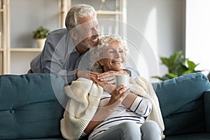 Affectionate senior married couple enjoying sweet tender cozy moment.