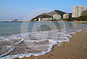 Affectionate South China Sea is washed by sand of Dadonghai Beach.