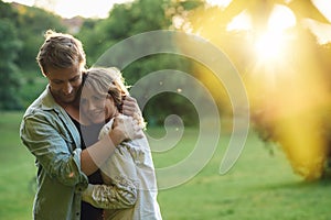 Affectionate young couple embracing outside at sunset
