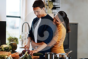 Affectionate young couple making dinner