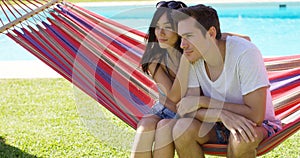 Affectionate young couple sitting on a hammock