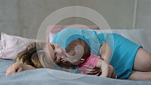 Affectionate young mother kissing her baby girl