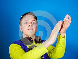 Affective teenage boy listening music in headphones