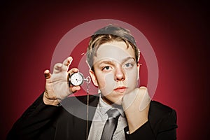 Affective teenage boy with watch showing time