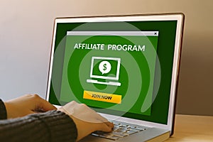 Affiliate program concept on laptop computer screen on wooden ta