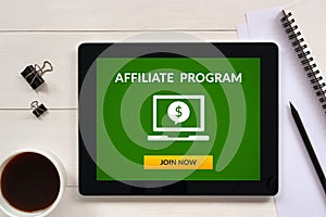 Affiliate program concept on tablet screen with office objects