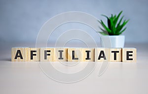 AFFILIATE word made with building blocks on blue.