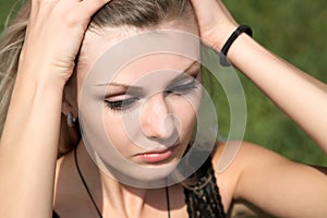 Afflicted girl keeps hands for a head