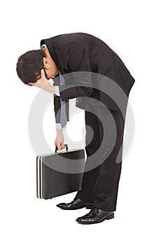 Afflictive businessman stoop and hold his head