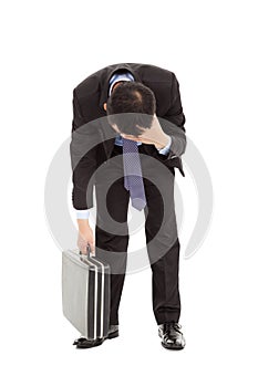 Afflictive businessman stoop and hold his head