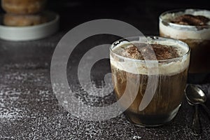 Affogato coffee with ice cream on a glass cup, dark, black background. Copy space