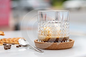 Affogato Coffee with vanilla ice cream in crystal glass on white marble table