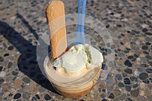 An affogato is an Italian coffee-based dessert. It usually takes the form of a scoop of vanilla gelato or ice cream