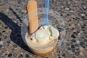 An affogato is an Italian coffee-based dessert. It usually takes the form of a scoop of vanilla gelato or ice cream photo