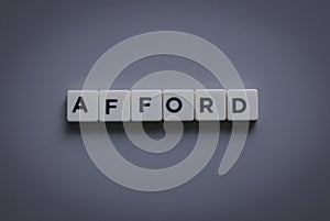 Afford word made of square letter word on gray background