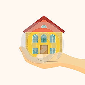 Affordable housing icon. House in hand vector illustration. Flat style photo