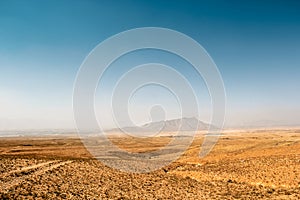 Afghanistan landscape, desert plain against the backdrop of mountains