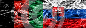 Afghanistan vs Slovakia smoke flags placed side by side. Thick colored silky smoke flags of Afghani and Slovakia.