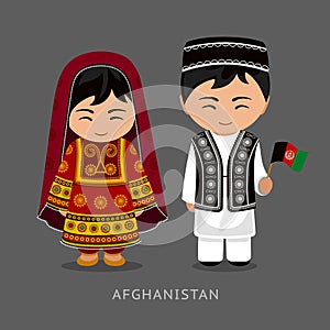 Afghans in national dress with a flag.