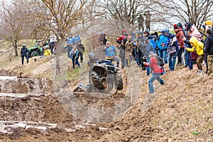 Afipsip, Russia - October 31, 2020: Sportsman on BRP quad bike drives splashing in dirt and water at Mud Racing contest. ATV SSV