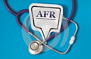 AFR - acronym on white figure sheet on a blue background with a stethoscope photo