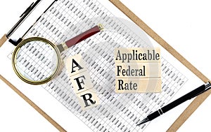AFR - Applicable Federal Rate text on wooden block on chart background photo