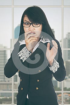 Afraid businesswoman standing in office