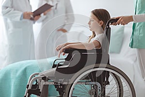 Afraid child on the wheelchair in the hospital