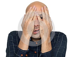 Afraid man covering his face with hands